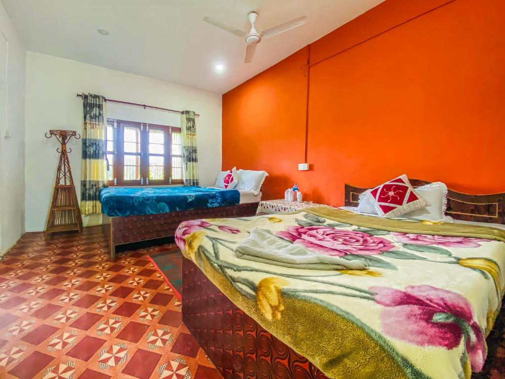 Family room with twin beds and vibrant orange accent walls